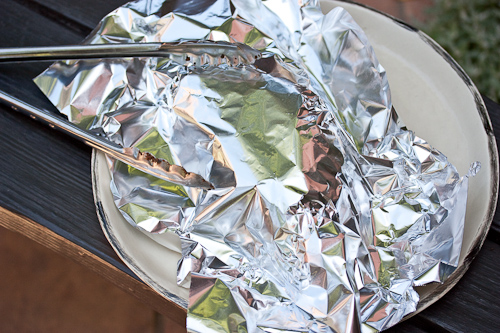 The foil isn't wrapped around the beef, but it is holding in the heat and steam and allowing the juices to flow back into the meat
