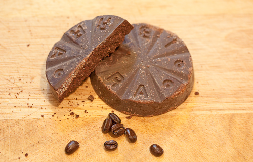 The chocolate disk, brand imprinted in the wedges, and a few coffee beans