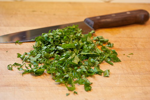 There is some argument that rinsing the basil washes away some of the oils that flavor it, but mine is from my garden and has to be washed