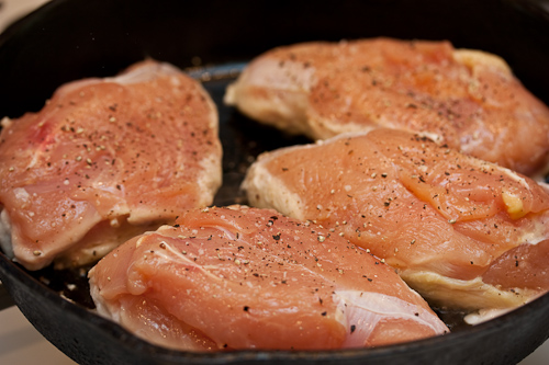 Some of the fat from the skin will render in the pan and keep the flesh side from sticking