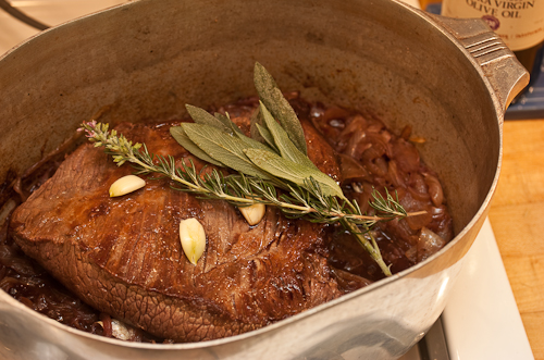 The garlic will dissolve into the broth, but the sprigs of sage and rosemary will be removed